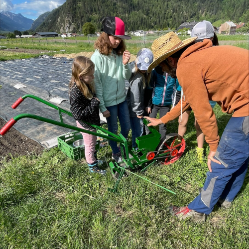 Workshop "Vom Acker auf den Teller" Kinder mit Max beim aussäen